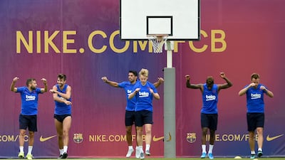 Barcelona players do stretching exercises. AFP