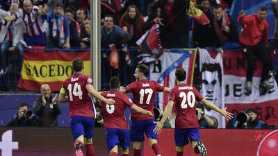 Atletico Madrid’s midfielder Saul Niguez (C) celebrate after scoring with teammates, Atletico Madrid’s midfielder Gabi, Atletico Madrid’s midfielder Koke and Atletico Madrid’s defender Juanfran during the Uefa Champions League semi-final first leg football match between Atletico Madrid and Bayern Munich at the Vicente Calderon stadium in Madrid on April 27, 2016. AFP / JAVIER SORIANO