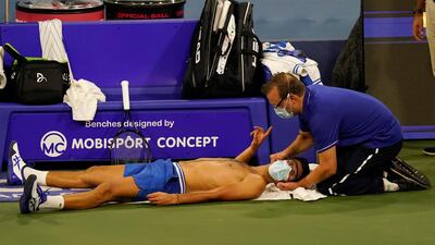 A trainer works on the neck of world No 1 Novak Djokovic during his victory over Ricardas Berankis in the second round of the Western and Southern Open tennis tournament on Monday, August 24. AP