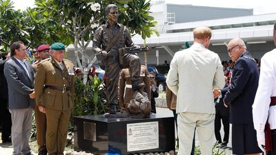 Britain's Prince Harry and Fiji's President Jioji Konrote stand in front of a new statue commemorating Sergeant Talaiasi Labalaba, a British-Fijian soldier who lost his life in the 1972 Battle of Mirbat. Reuters