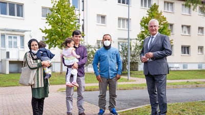 Afghan evacuees speak to Bavarian Interior Minister Joachim Hermann, right, at an asylum centre in Bamberg, Germany.