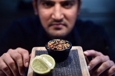 El Topo sous-chef Nowshad Alam Rasel shows off his restaurant's signature cricket dish in Sydney, Australia. AFP