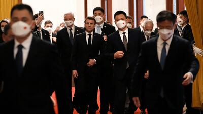 Mr Macron arrives for a meeting with Chinese Premier Li Qiang in Beijing. AP