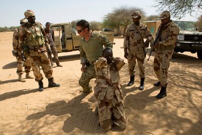 A US special forces soldier demonstrates how to detain a suspect during a mission for African militaries in Niger. Reuters