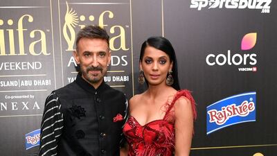 Rahul Dev in black and Mugdha Godse in a rich red gown. AFP