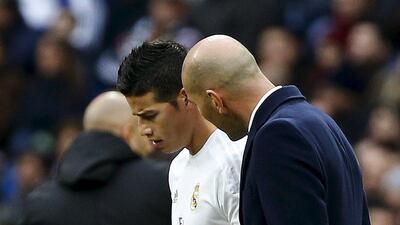 Real Madrid manager Zinedine Zidane talks to James Rodriguez during the club's La Liga match against Sporting Gijon last weekend. Andrea Comas / Reuters / January 17, 2016