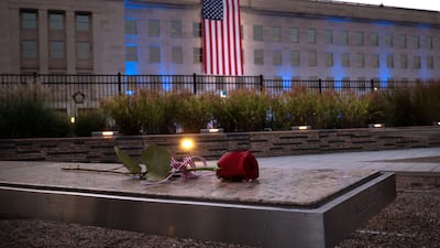 A rose lays on a bench at the National 9/11 Pentagon Memorial in Arlington, Virginia. The nation is marking the 20th anniversary of the terror attacks of September 11, 2001, when the terrorist group al-Qaeda flew hijacked airplanes into the World Trade Center, Shanksville, PA and the Pentagon, killing nearly 3,000 people. AFP