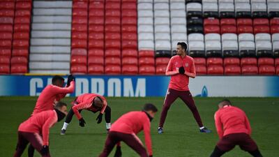 Barcelona's Spanish midfielder Sergio Busquets (2nd R) and teammates attend a training session at Old Trafford stadium in Manchester, north west England on the eve of their UEFA Champions League quarter final first leg football match against Manchester United. AFP