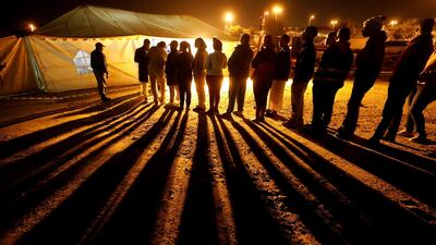 Voters queue to cast their ballots before polls close outside a polling station in Alexandra township in Johannesburg, South Africa. Reuters