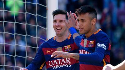 Barcelona’s Argentinian forward Lionel Messi (L) and Barcelona’s Brazilian forward Neymar celebrate an Getafe’s own goal during the Spanish league football match FC Barcelona vs Getafe CF at the Camp Nou stadium in Barcelona on March 12, 2016. AFP / LLUIS GENE