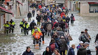 People wade through high water in Venice, northern Italy last week. Andrea Merola / EPA