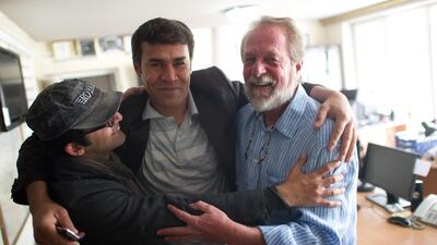 In this file photo, taken in 2012, AFP photographer Shah Marai, centre, embraces colleagues Massoud Hossaini and Lawrence Bartlett after Hossaini had won the Pulitzer Prize, at the AFP office in Kabul. AFP's chief photographer in Kabul, Shah Marai, was killed in a secondary explosion targeting a group of journalists who had rushed to the scene of a suicide blast in the Afghan capital. Here is a collection of his work. Johannes Eisele / AFP