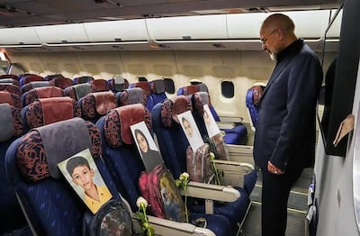 Iranian Parliamentary Speaker Mohammad-Bagher Ghalibaf looks at the photos of the children killed in Madrasa Minab in Iran, while aboard a plane on his way to Pakistan for talks with the US. AFP