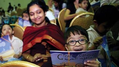 Taher Dilawar watches Creative Caravan clowns perform at Al Noor Special Needs Center.