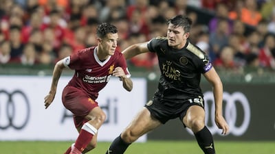 Liverpool midfielder Philippe Coutinho, left, competes for the ball with Leicester City defender Harry Maguire during their Premier League Asia Trophy match at Hong Kong. Victor Fraile / Getty Images