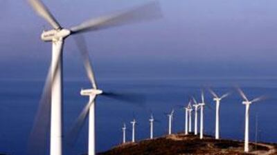 The blades of turbines on a wind farm catch the wind in front of Aegean Sea on Evia island, off the eastern coast of Greece.