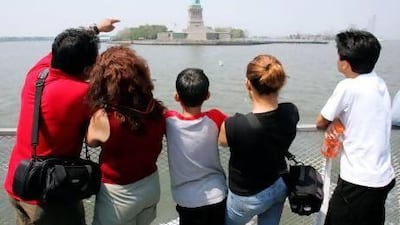 A group of tourists look at the Statue of Liberty in New York. Emiratis can now complete the US visa process in a week at quiet times and three weeks during peak season. AFP PHOTO/DON EMMERT