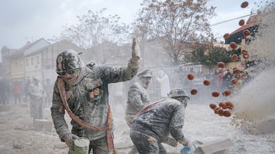 Revellers dressed in mock military uniforms in Ibi, Alicante, eastern Spain, throw flour and eggs at each other at the Els Enfarinats festival (The Flour-Covered Ones). EPA
