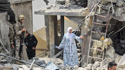 A woman makes her way through the rubble of a residential building hit in an Israeli attack, near Burj Al Shamali, on the outskirts of Tyre. AFP