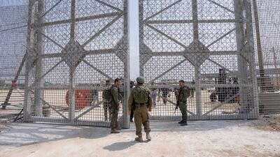 Israeli soldiers at the gate of an inspection area for lorries carrying humanitarian aid supplies for Palestinians, on the Israeli side of the Erez crossing into northern Gaza, May 2024. AP