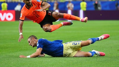 Gustaf Lagerbielke of Sweden tackles Cody Gakpo of the Netherlands in Houston, US. EPA
