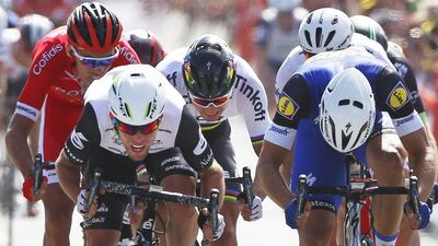 British sprinter Mark Cavendish, left, crosses the finish line ahead of Peter Sagan of Slovakia, centre rear, and Germany’s sprinter Marcel Kittel, right, to win the first stage of the Tour de France cycling race from Mont Saint-Michel to Utah Beach, France, Saturday, July 2, 2016. Peter Dejong / AP Photo
