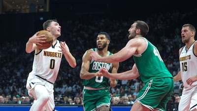 Denver Nuggets’ Christian Braun takes on Boston Celtics' Jayson Tatum and Luke Kornet. Victor Besa / The National