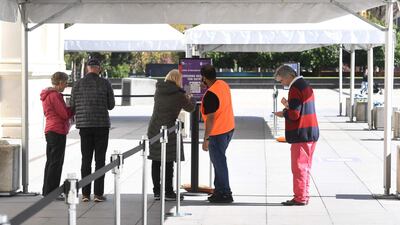 People wait outside a Covid-19 vaccination centre to receive the shot in Melbourne, Australia, on April 21, 2021. AFP