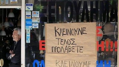 A Greek shopowner announces closure. Short-sellers are suspected to have speculated on the collapse of the Greek economy. Orestis Panagiotou / EPA