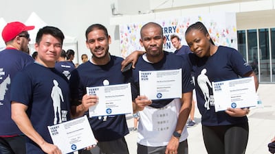 Runners show their finishing certificates.