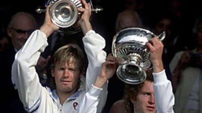 John McEnroe, right, and Peter Fleming show off their trophies after winning the 1981 Wimbledon men's doubles final