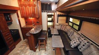 Interior photograph of the kitchen and living room in the XLR Thunderbolt RV by Forest River on sale at Gulf Coast RVs in Dubai