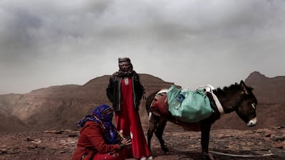 Umm Yasser, the first Bedouin female guide from the Hamada tribe, looks at Umm Soliman as she plays the flute, near Wadi Sahw, Abu Zenima, in South Sinai, Egypt. AP Photo