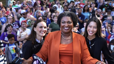 Portman with Ms Abrams and Democratic candidate for Georgia secretary of state Bee Nguyen. Getty / AFP