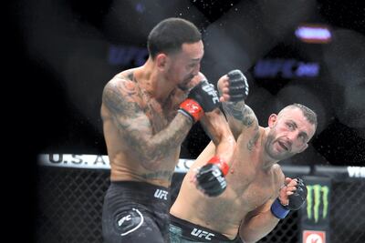 Alexander Volkanovski punches Max Holloway in their title fight at UFC 245 in Las Vegas. AFP