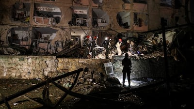 Emergency workers search through the rubble in Arad. Reuters
