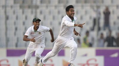Bangladesh's Mehedi Hasan, right, and teammate Taijul Islam celebrate after their victory over England on Sunday. AM Ahad / AP Photo / October 30, 2016