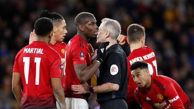 Manchester United's Paul Pogba speaks with referee Martin Atkinson during the match. Reuters