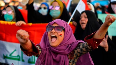 An Iraqi women chant slogans and wave their country's national flag during during anti-government protests in the central Iraqi holy city of Najaf on October 30, 2019. AFP