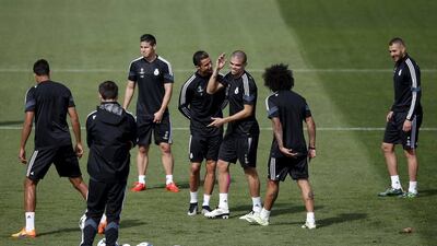 Cristiano Ronaldo, left centre, and Pepe share a joke during a Real Madrid training session ahead of their Uefa Champions League quarter-final first leg against Atletico Madrid. Susana Vera / Reuters