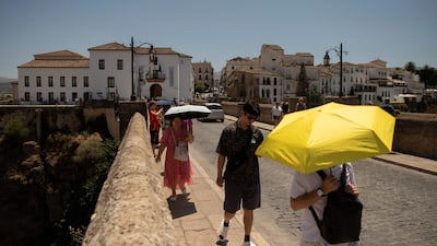 Tourists shelter from the sun during a heatwave in Ronda, southern Spain, in August. AFP