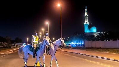 The horses have no traffic to contend with - and the streets are deserted due to the curfew. Reem Mohammed / The National