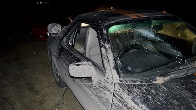 A car belonging to the BBC television program Top Gear crew sits abandoned along a road after it was attacked near Rio Grande, Argentina, on Friday, October 3, 2014. The host of the program and other members of the crew fled Argentina on Friday after being pelted with rocks by people who believed one of their cars had a license plate alluding to the Falklands War. AP