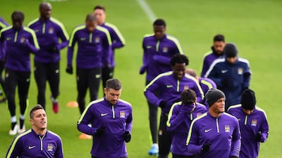 From left to right, Stevan Jovetic, Aleksandar Kolarov and Vincent Kompany of Manchester City jog during a Champions League team training session on Monday. Laurence Griffiths / Getty Images