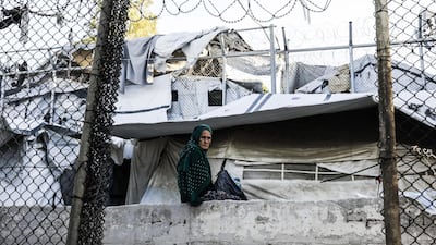 LESBOS, GREECE - SEPTEMBER 30: Moria camp refugees gaze at the aftermath of a fatal fire that claimed the life of a woman and a child the night beforeon September 30, 2019 in Lesbos, Greece. Clashes between refugees and police resulted after the blaze, where 12,000 refugees and migrants remain trapped in squalid living conditions on Lesvos Island in Greece on Sunday. (Photo by Byron Smith/Getty Images)