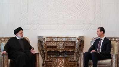 Ebrahim Raisi and Syria's Bashar Al Assad at the presidential palace in Damascus on Wednesday. AFP