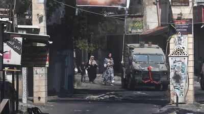 Members of the Palestine Red Crescent Society (PRCS) help refugees to evacuate Jenin Camp to a safe place during the second day of an Israeli military operation in Jenin refugee camp on July 4. EPA