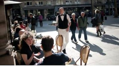 People enjoy the warm sunshine in Paris. The French government plans to cap public sector bosses' pay at €450,000 a year, or no more than 20 times the lowest salary in the business. Fred Dufour / AFP