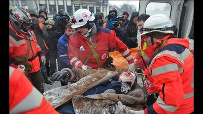 Medical workers help an injured man during anti-government protest in downtown Kiev. At least two protesters died during violent clashes with police in Kiev. Alexey Furman / EPA