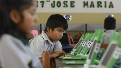 A boy uses his laptop at the Jose Maria public school in a shantytown on the outskirts of Lima, Peru. Karel Navarro / AP Photo